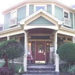 Cobblestone green building with red door