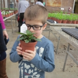 child smelling a plant