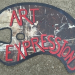 artist palette sign with red letters